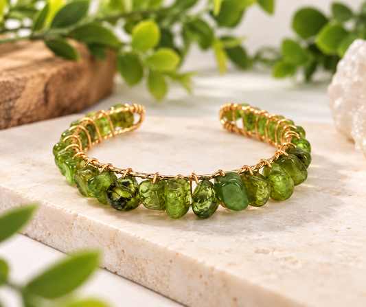 Natural green peridot gemstone bangle cuff bracelet featuring 18kt gold overlay wire wrapping.