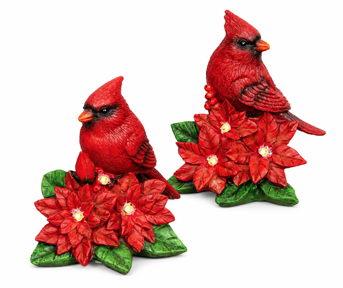 LED lighted red cardinal nestled in festive poinsettias, rustic carved resin Christmas figurine with warm white lights.