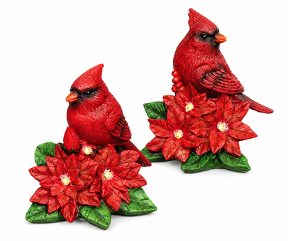 LED lighted red cardinal nestled in festive poinsettias, rustic carved resin Christmas figurine with warm white lights.