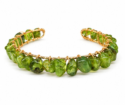 Natural green peridot gemstone bangle cuff bracelet featuring 18kt gold overlay wire wrapping and flexible open cuff design at Milliee's Boutique.